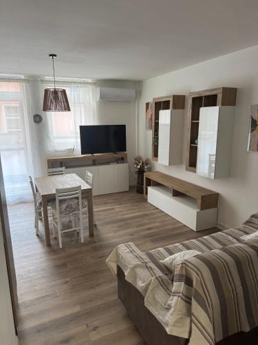 a living room with a bed and a table at Private Parking - A Casa di Anna in Borgo