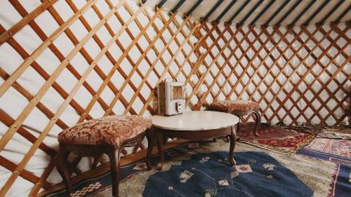 a room with a table with a sewing machine on it at Cosy yurt at a nature retreat in Dunlap CA in Miramonte