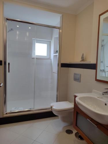 a bathroom with a shower and a toilet and a sink at O Pomar in Cabanas by Wave Algarve in Cabanas de Tavira
