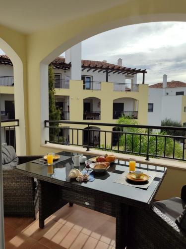 a table with food on top of a balcony at O Pomar in Cabanas by Wave Algarve in Cabanas de Tavira