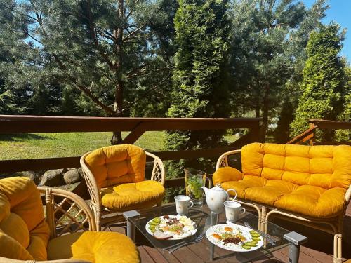 a patio with chairs and a table with food on it at Amalka Wita in Sulęczyno