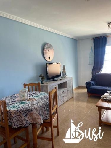 a living room with a table and a tv at Susi in Santa Cruz de la Palma