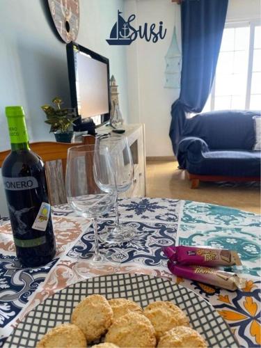 a table with a bottle of wine and a plate of biscuits at Susi in Santa Cruz de la Palma