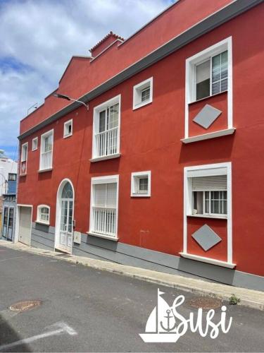 a red building on the side of a street at Susi in Santa Cruz de la Palma