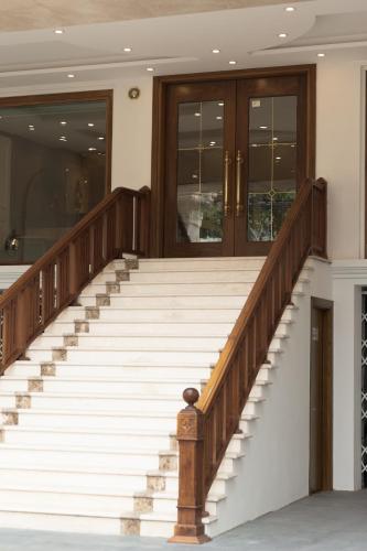 a set of stairs in a building with wooden doors at Hanoi Sail Hotel in Hanoi