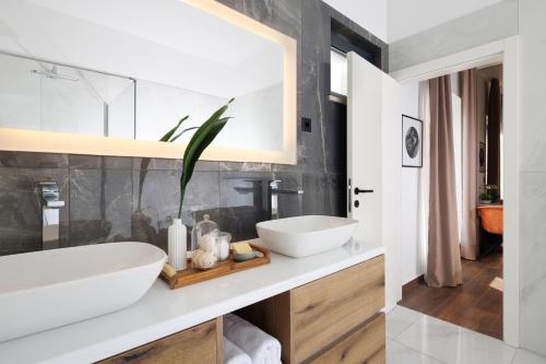 a bathroom with a white sink and a mirror at Villa Luxor in Zambratija