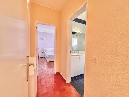a hallway with an open door to a bathroom at Vilamoura Central 10 by Homing in Vilamoura