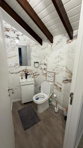 a bathroom with a toilet and a sink at Amazing Home in Ponta Garça