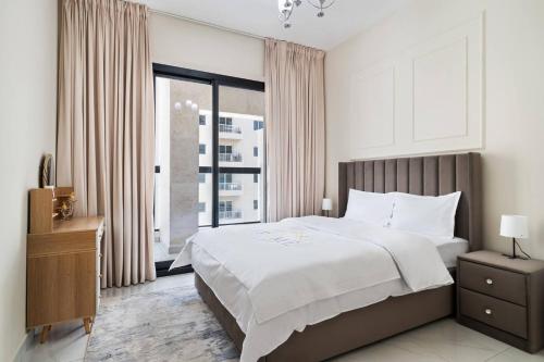 a bedroom with a large bed and a large window at Super Deluxe Apartmentpool in Dubai