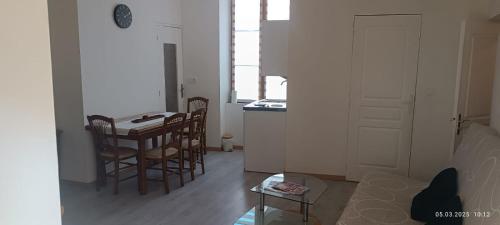a kitchen and dining room with a table and chairs at Appartement Artur 2 in Bar-sur-Aube