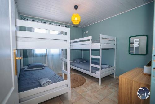 two bunk beds in a room with blue walls at Villa et appartement à Goudargues in Goudargues