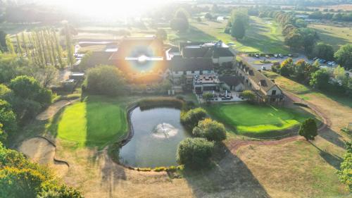 an aerial view of a resort with a pond at Bicester Hotel, Golf & Spa in Bicester