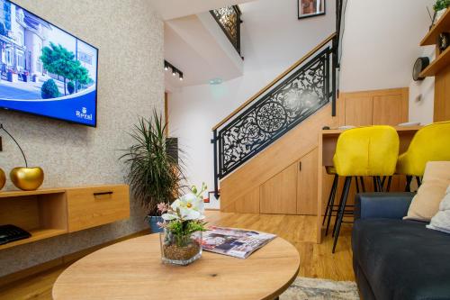 a living room with a couch and a table at Garni Hotel Royal Crown in Subotica