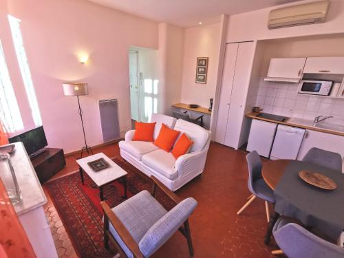 カンヌにあるAppartements 7 Florianのリビングルーム(白いソファ、オレンジの枕付)
