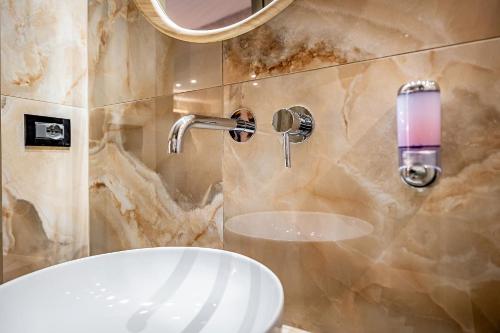 a bathroom with a white sink and a mirror at Hotel Duomo Firenze in Florence