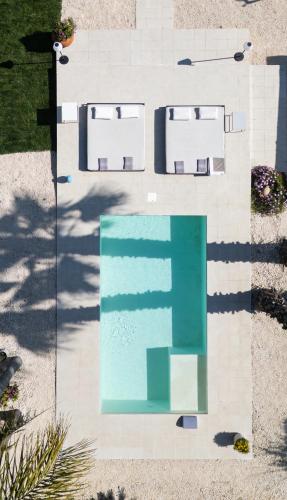 an overhead view of a swimming pool with a green at Villa Nunziatina in Carlentini