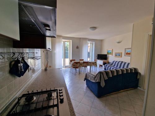a kitchen and living room with a couch and a stove at Villa Sante Residence in Pesaro