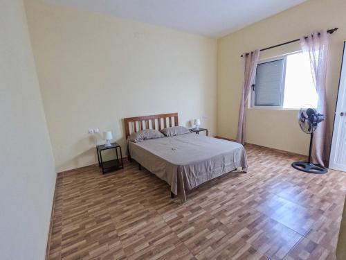 a bedroom with a bed and a large window at GoBeyond - T2 Selada in Porto Novo