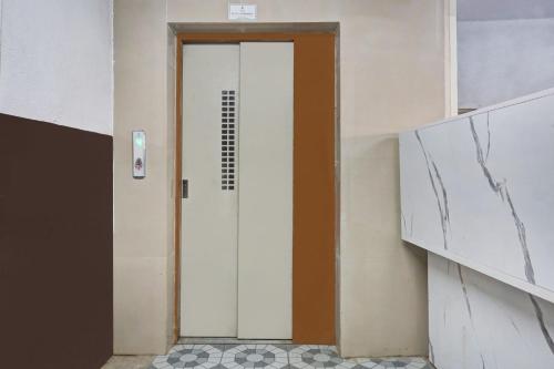 a door in a room with a tile floor at Hotel O Sai Avenue in Pune