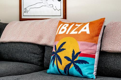a pillow on the back of a couch with a bikers pillow at 82A Dalston Lane Terrace in London
