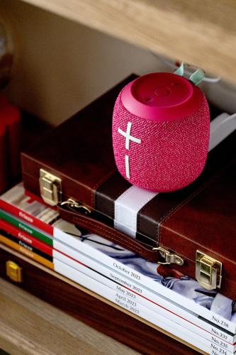 a pink alarm clock sitting on top of books at 82A Dalston Lane Terrace in London
