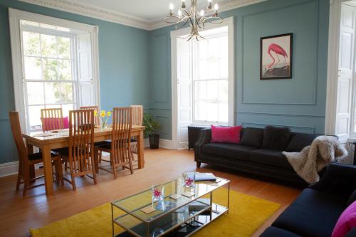 a living room with a couch and a table at Starbright Cottage in Peebles