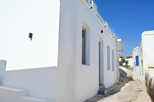 a row of white buildings on a street at Evridiki apartments in Kithnos