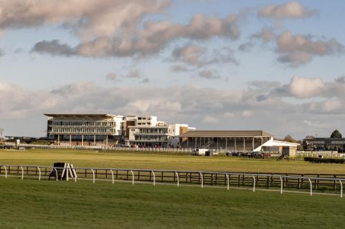 a view of a race track with a building in the background at Solaris in York