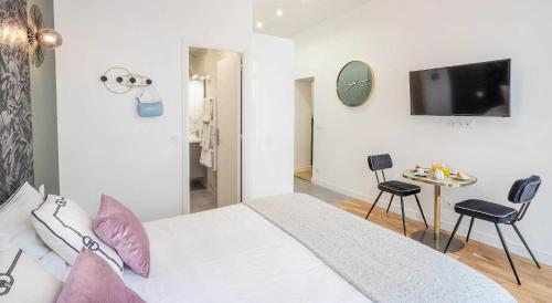 une chambre avec un lit et une table avec des chaises dans l'établissement Cosy Studio in the heart of Belleville, à Paris