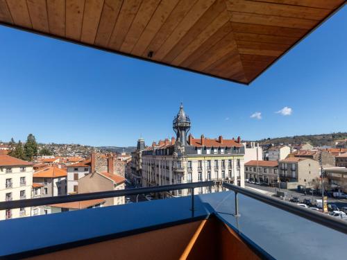 a view of the city from the balcony of a building at ibis Styles Le Puy en Velay in Le Puy en Velay