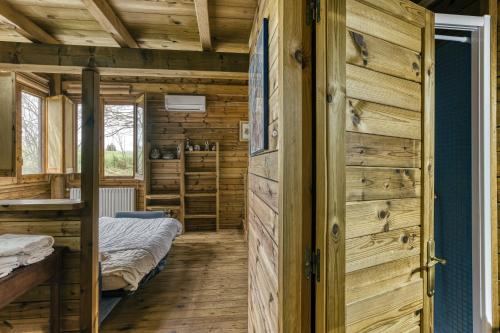 a room with two beds and wooden walls at Habitacions Mas Fuselles in Girona