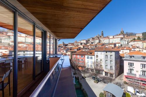 a view of the city from the balcony of a building at ibis Styles Le Puy en Velay in Le Puy en Velay