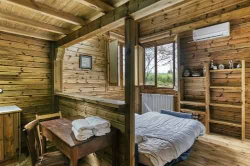 a room with a bed and a table in it at Habitacions Mas Fuselles in Girona