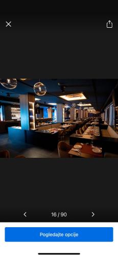 a picture of a restaurant with tables and chairs at Apartman Magdalena Kopaonik in Cajetina