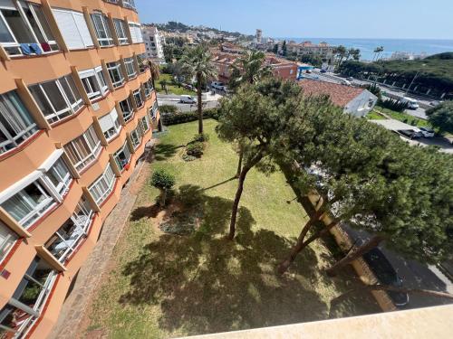 an aerial view of a building with trees in front of it at Calypso Holidays II in Sitio de Calahonda