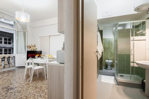 a bathroom with a sink and a table in a room at Fieno - Genoa Historic Center and Aquarium in Genova