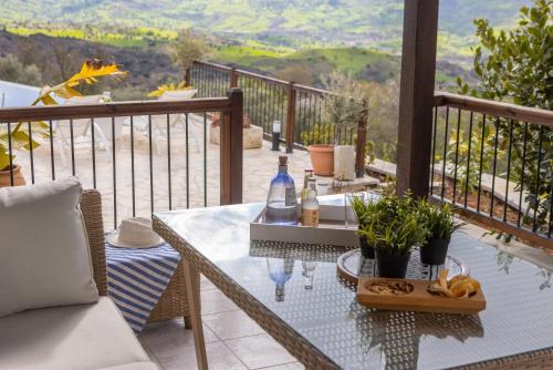 a patio with a table and a view of a valley at Casale Xenia in Lyso