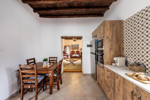 a kitchen with a table and a dining room at Casale Xenia in Lyso