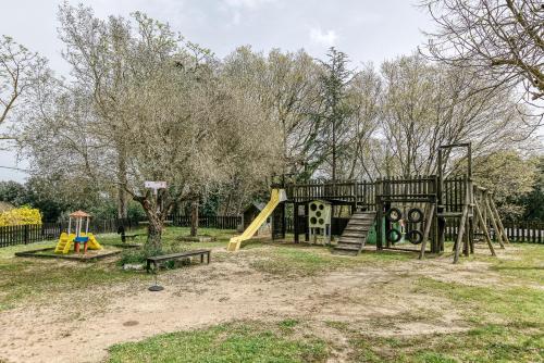 a park with a playground with a slide at Habitacions Mas Fuselles in Girona