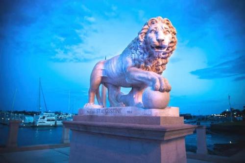 a statue of a lion sitting on top of a building at Coastal Condo - Walk to Beach Pool Pickleball and Boat Ramp in Saint Augustine