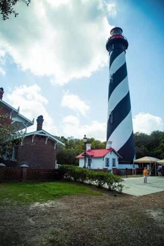 a lighthouse sitting on top of a building at Coastal Condo - Walk to Beach Pool Pickleball and Boat Ramp in Saint Augustine