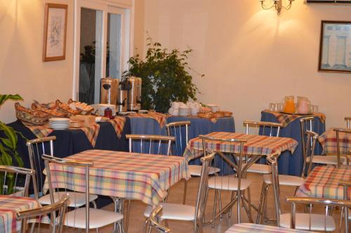 a room with tables and chairs with blue and orange table cloth at Solanas Termas de Dayman in Termas del Daymán