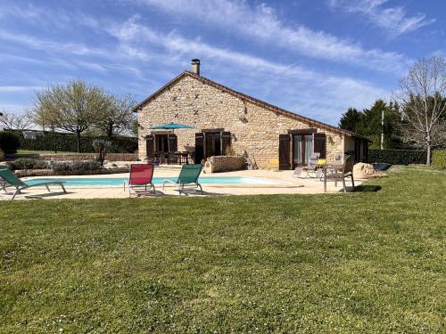 a house with chairs and a pool in front of it at Maison M in Surin