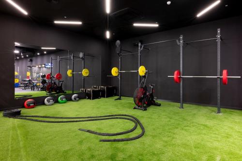 a gym with a green carpeted floor with boxing equipment at GF Victoria in Adeje