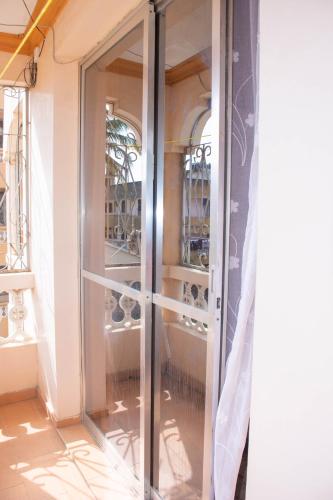 a sliding glass door in a room with glasses at Bamburi Luxury Homes III One bedroom apartment in Bamburi