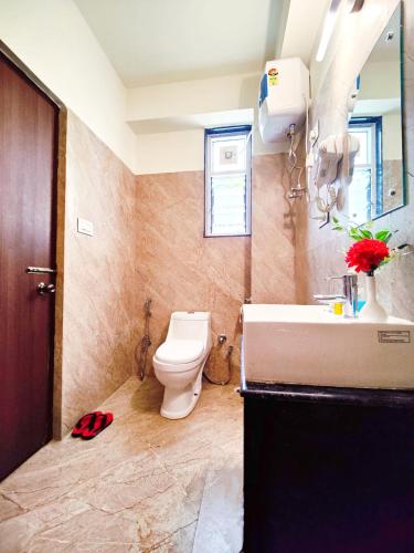 a bathroom with a toilet and a sink at Jo'stel Dream Glory Hotel and Bar - Near MG Marg in Gangtok