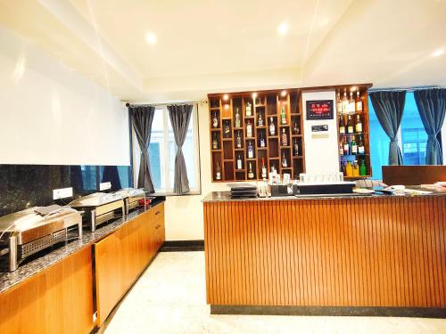 a restaurant with a counter and a bar at Jo'stel Dream Glory Hotel and Bar - Near MG Marg in Gangtok