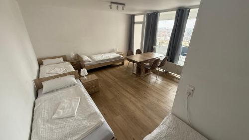 a dorm room with two beds and a table at Apartment Hannover-Airport! contactless check-in in Hannover