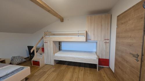 a small bedroom with a bunk bed and a bunk bed at Heu und Himmel Loft in Innsbruck