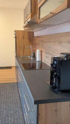 a kitchen with a sink and a counter top at Heu und Himmel Loft in Innsbruck